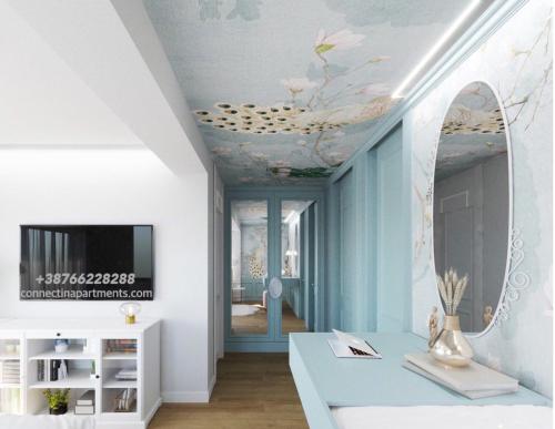 帕莱ConnectIN Apartments的客厅设有花卉装饰的天花板