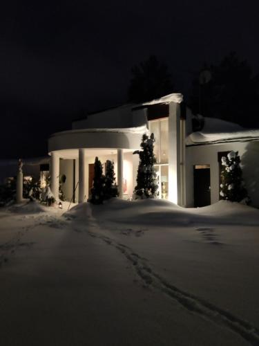 凯乌鲁Pikkukoti Villa的雪中的一个白色房子