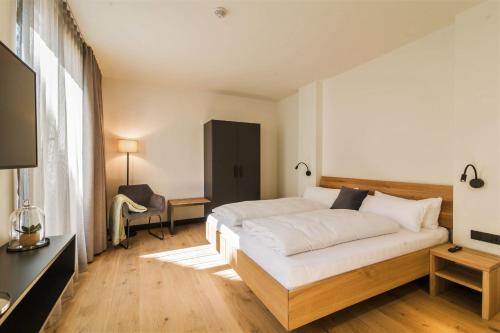 BissersheimWeinQuartier Bissersheim的卧室配有一张白色大床和电视。