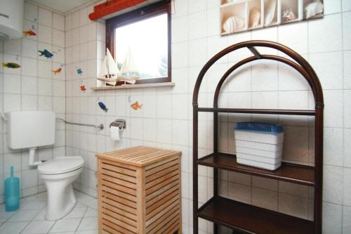 Klein SprenzCottage, Dolgen am See的一间带卫生间、窗户和架子的浴室