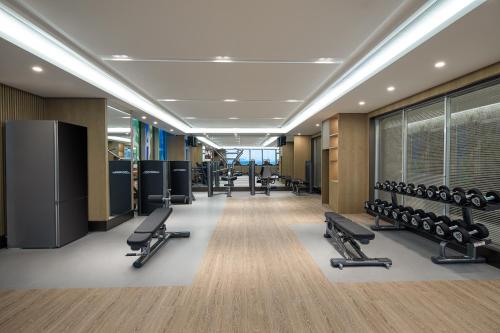 无锡无锡雅诗阁新发服务公寓的健身房,设有一排椅子和举重器材