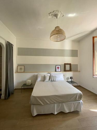 基亚瓦里Casetta di Mari, CinqueTerreCoast的卧室配有一张白色大床和吊灯。