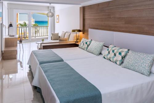 滨海罗克塔斯Mediterraneo Bay Hotel & Resort的一间带大床的卧室和一间客厅