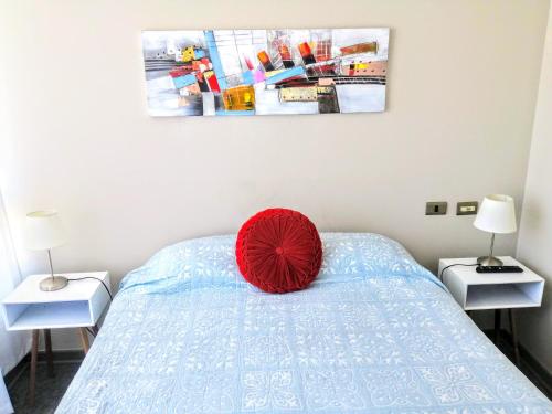 卡拉马2 Torres Calama的卧室床上的红色枕头