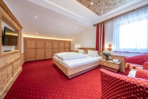 温特斯密仁酒店的一间卧室配有一张床,铺有红色地毯