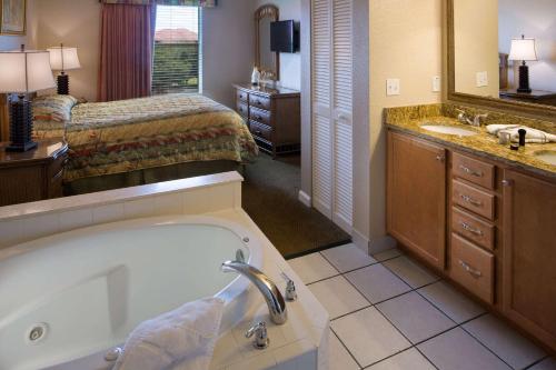 基西米Vacation Villas 2, a Ramada by Wyndham的带浴缸的浴室和1间带1张床的卧室