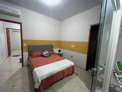 里约布兰科Flat hotel Victoram的一间卧室设有一张床和一个玻璃淋浴间