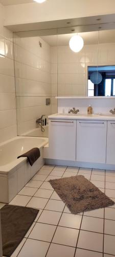 布鲁日Bruges Grande Place Guesthouse的带浴缸、水槽和镜子的浴室