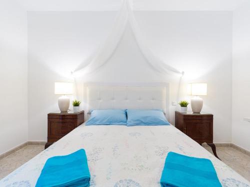 维辛达里奥Surf Brothers的一间卧室配有白色的床和2把蓝色椅子