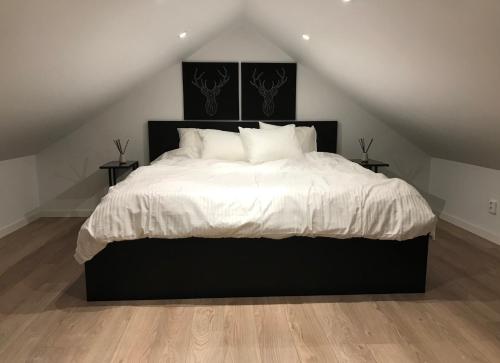 博伦厄Backes Lillstuga的卧室配有一张带白色床单和枕头的大床。