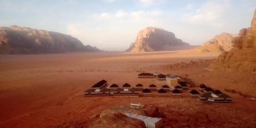 瓦迪拉姆Wadi Rum Quiet Village Camp的一座位于沙漠中群山的建筑