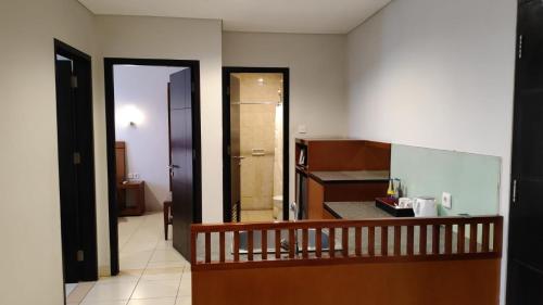 勒吉安库塔大酒店的走廊通往带浴室的客房