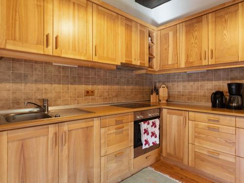 EbersteinHoliday home in Eberstein Carinthia with sauna的一个带木制橱柜和水槽的厨房