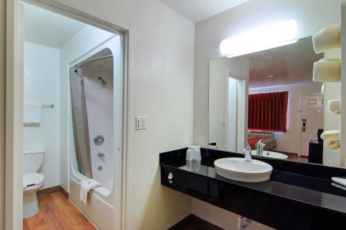 斯科茨Motel 6 Old town Scottsdale Fashion Square的一间带水槽、卫生间和镜子的浴室
