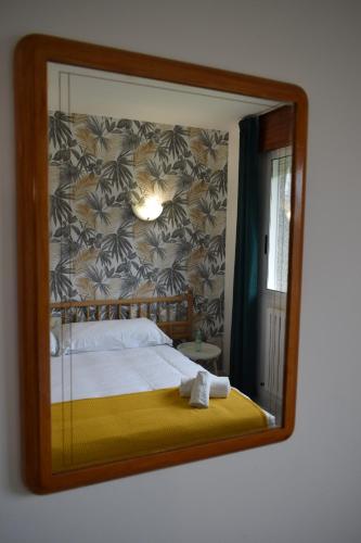 桑亨霍Hotel VIDA Xunca Blanca的镜子反射着房间里的床