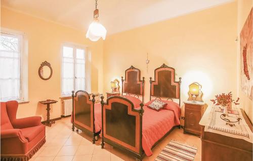PortacomaroLa Locanda的一间卧室配有一张大床和一张红色椅子