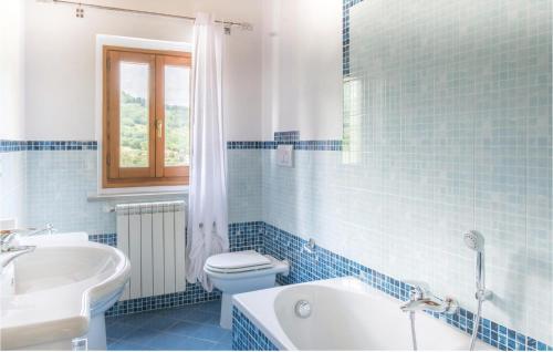 迪科马诺迪科马诺*XXVI*号度假屋的蓝色瓷砖浴室设有卫生间和水槽