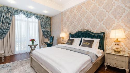 基希讷乌GREGORY Boutique Hotel Chisinau的一间卧室配有一张大床和绿色床头板