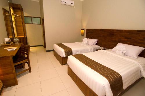 Syailendra Hotel Syariah客房内的一张或多张床位