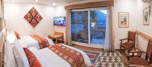 罕萨SERENA ALTIT FORT RESIDENCE的酒店客房设有两张床和窗户。