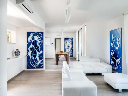 陶尔米纳贝拉岛公寓的客厅配有白色家具和蓝色及白色的墙壁