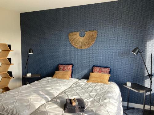 圣迪耶La Tuilerie Chambres d'Hôtes的一间卧室设有一张蓝色墙壁的大床