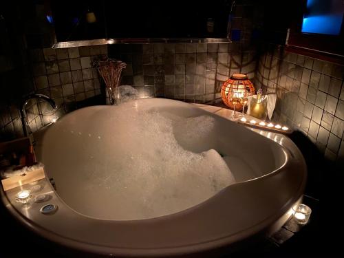 埃尔乔罗柯波尔佳甘塔酒店的浴室内设有带灯的大浴缸
