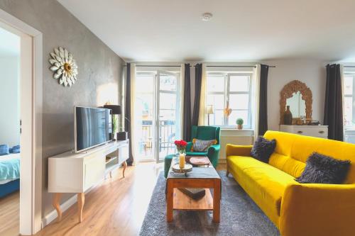 埃尔布隆格Bea Home Elblag - dwie sypialnie的客厅设有黄色沙发和电视