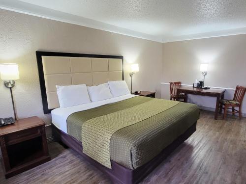 圣安东尼奥Flex Studios的酒店客房设有一张大床和两张桌子。