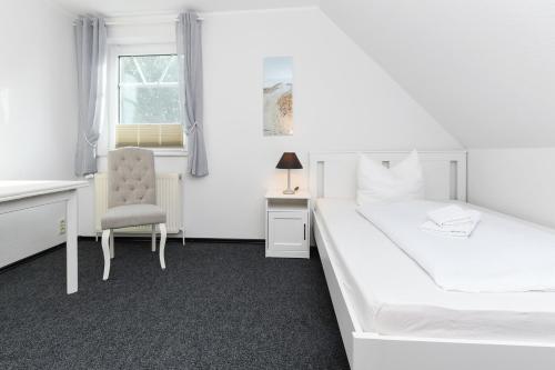 Hotel-Pension Janssen - Gästehaus Huus an't Deep客房内的一张或多张床位