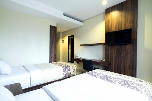 Prasada Mansion Sudirman客房内的一张或多张床位