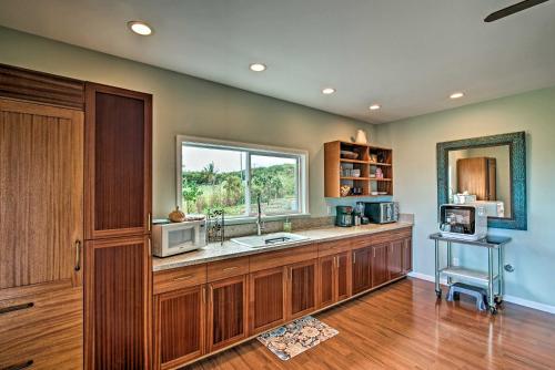 NaalehuThe Aloha Green House Retreat with Ocean Views!的厨房配有带水槽的柜台和窗户。