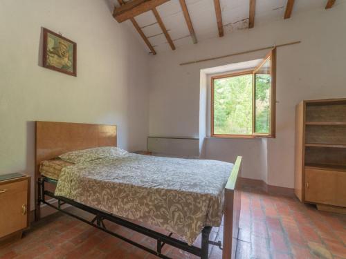 阿夸拉尼亚Authentic holiday home in Cagli with private swimming pool的一间卧室设有一张床和一个窗口