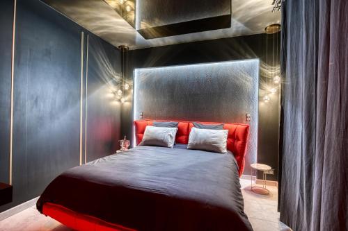 圣西尔-莱科勒Villa avec jacuzzi privatif的一间卧室配有一张红色床头板的床