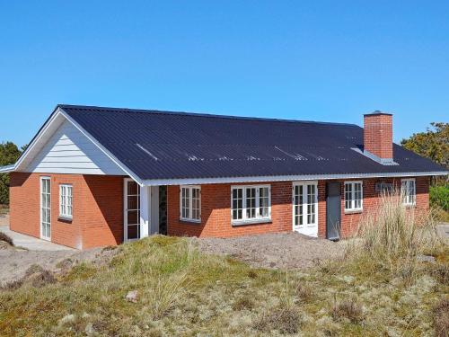凡岛4 person holiday home in Fan的一座红砖房子,上面有太阳能电池板