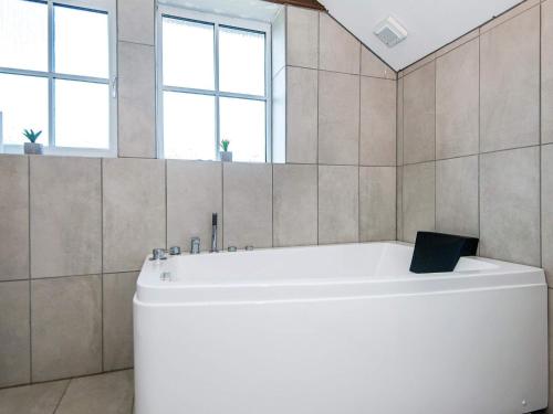 安斯艾厄6 person holiday home in Ansager的带窗户的浴室内的白色浴缸