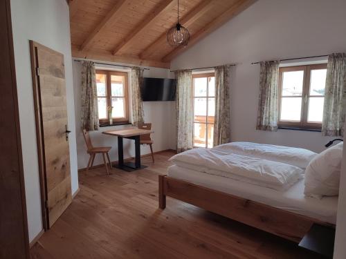 巴特海尔布伦Landhaus Hutter的卧室配有一张床、一张书桌和窗户。