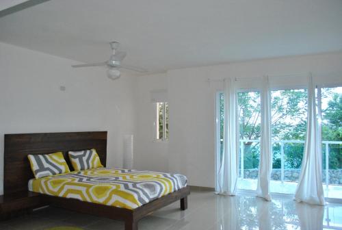 海地角Vue Apartment Hotel的一间卧室设有一张床和一个大窗户