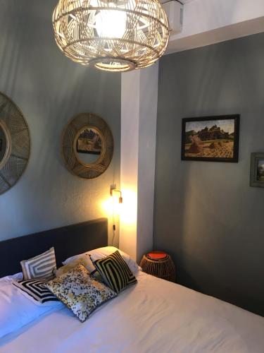 巴斯蒂亚Chambre Rose的一间卧室配有一张床和一个吊灯