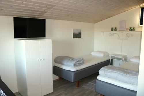 奥胡斯Kärraton Stugor的客房设有两张床和一台平面电视。
