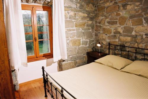 DekaniBordon wines, estate with accommodation的一间卧室设有一张床和石墙