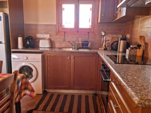 AnaritaFontana Traditional House的厨房配有水槽和洗衣机
