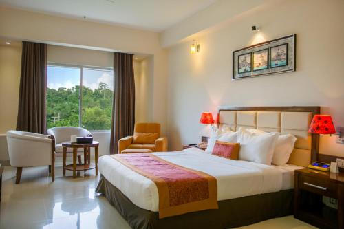 库克斯巴扎Sea Pearl Beach Resort & Spa Cox's Bazar的酒店客房带一张床、一张桌子和椅子
