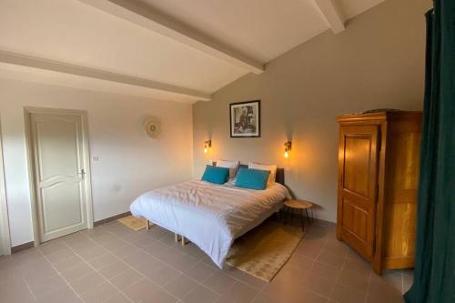 波尔蒂乔Villa 180 m2 vue Mer au calme grand terrain Porticcio的一间卧室配有一张带蓝色枕头的床
