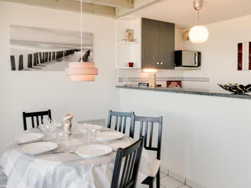 米尼赞海滩Apartment Grand Pavois-2 by Interhome的一间带桌子的用餐室和一间厨房