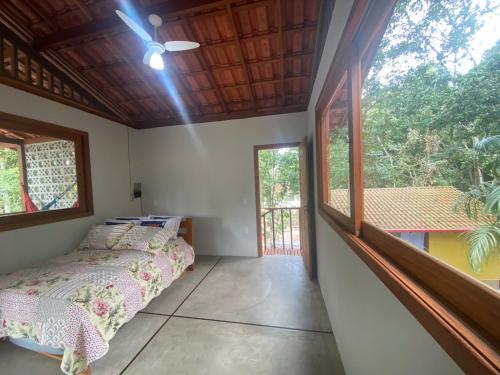 库穆鲁沙蒂巴Chalés Cumuruxatiba的一间卧室设有一张床和一个大窗户