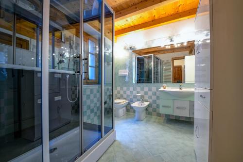 特雷莫西内Casa nel Borgo - Casa Oliva的带淋浴、卫生间和盥洗盆的浴室
