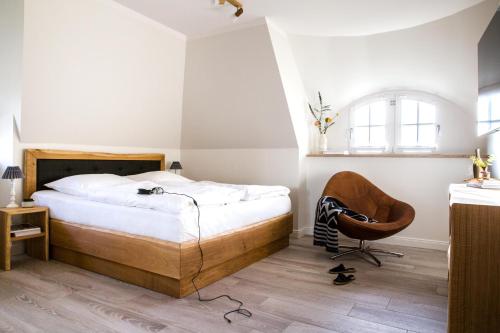 富伦多夫Ferienhaus Seeadler 9的一间卧室配有一张床和一把椅子