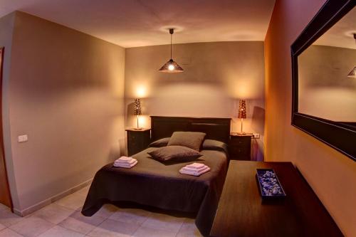 莱斯普卢加德夫兰科利卡拉伯乐塔公寓式酒店的一间小卧室,配有一张床和一张桌子