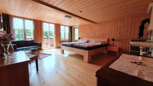 OeyAdlerhorst - Apartment im Niedersimmetal的一间卧室配有一张床和一个沙发